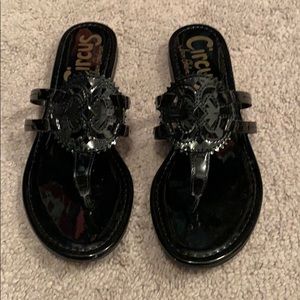 Black medallion sandals.